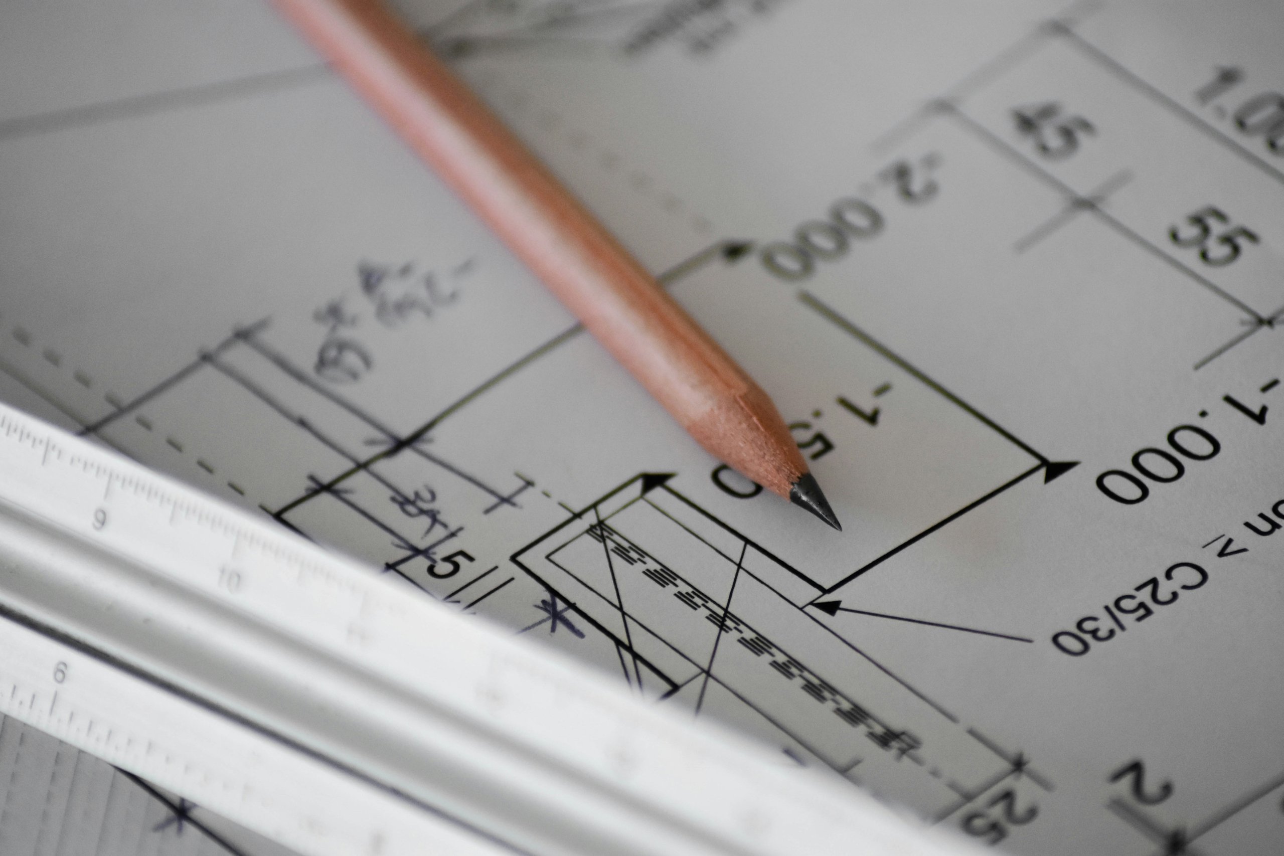 forensic-what-we-provide-A-pencil-on-plans Engineer reviewing structural plans
